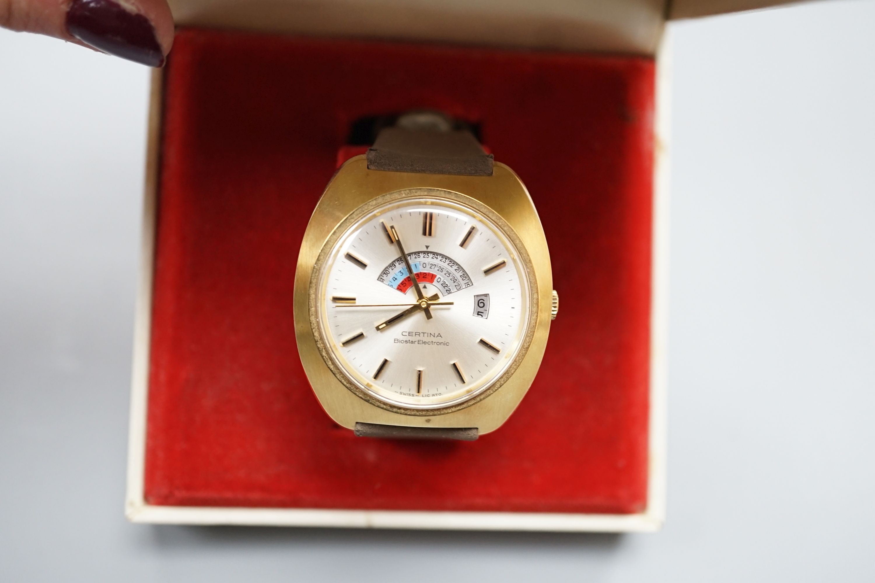 A gentleman's 1970's gilt and steel Certina Biostar Electrinic wrist watch, on Certina strap, case diameter 39mm, with Certina box.